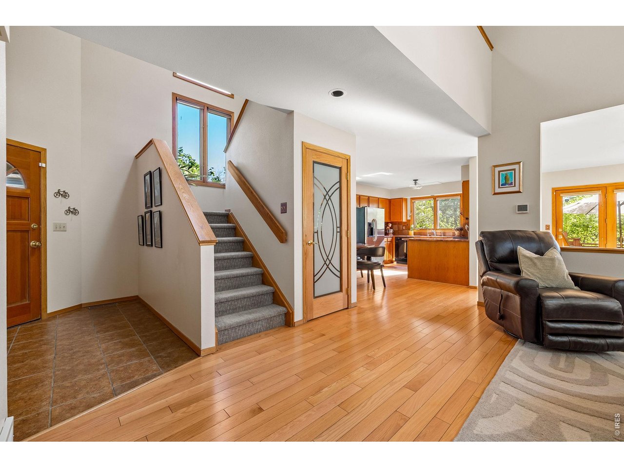 Head up the skylit staircase to the upper level primary suite and guest bedrooms.