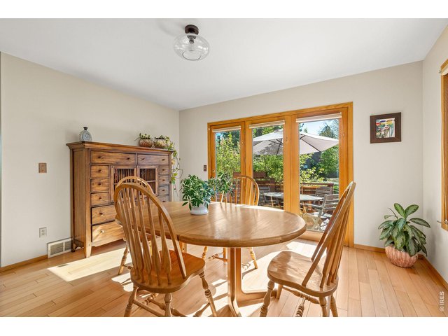 Property Photo 22 Oversized windows frame the dining room space with direct access to the adjacent spacious deck. 