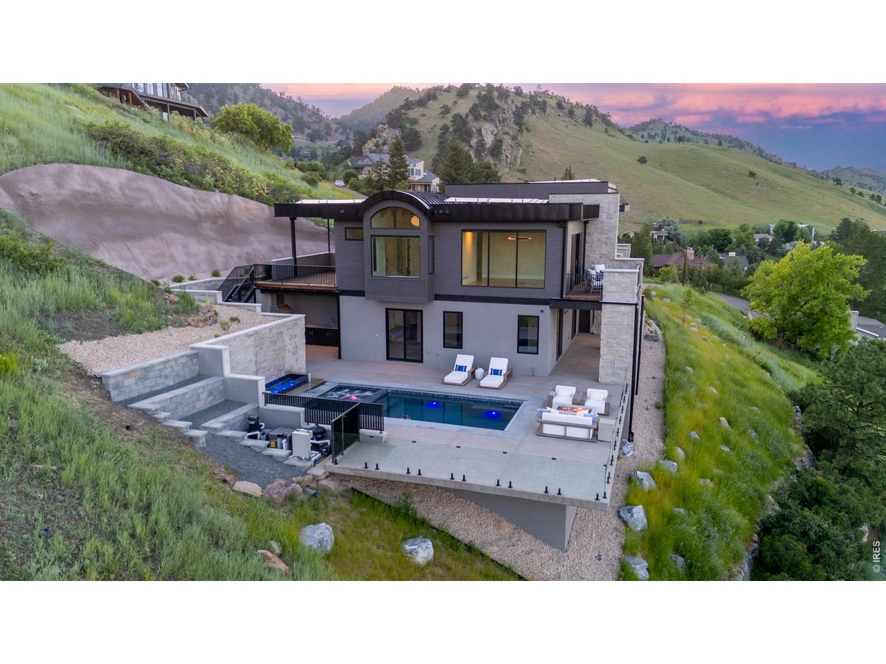 Set against a backdrop of unimpeded, panoramic views of the city and foothills, every space is thoughtfully designed to capture light, scale, and scenery through soaring ceilings and dramatic walls of glass.