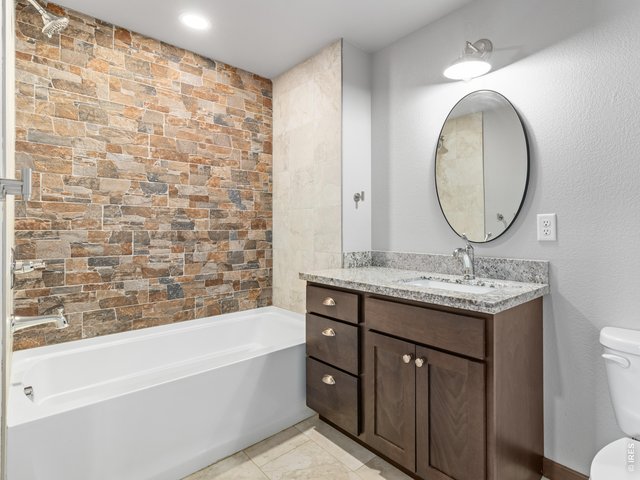 Property Photo 25 Guest bath with custom tile wall