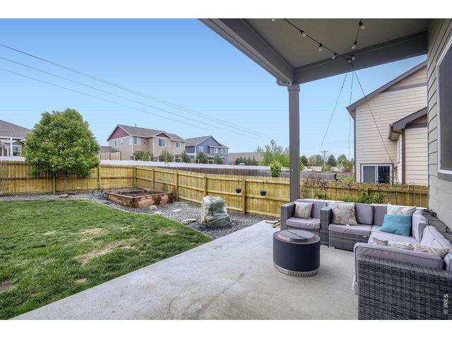 Property Photo 25 Covered back patio with lights & TV