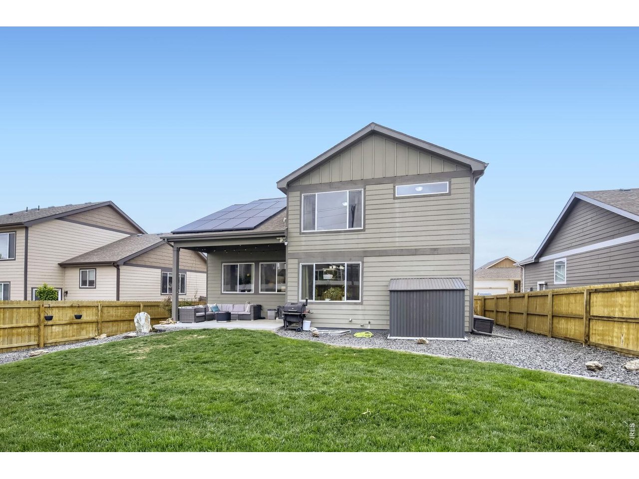 Large backyard with professional landscape and planter bed