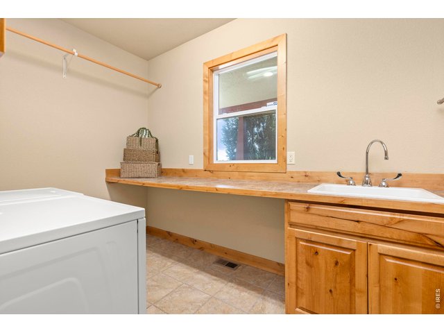 Property Photo 28 Large Laundry Room with Sink and Folding Counter