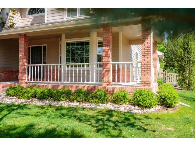 Property Photo 4 Charming wrap-around porch ideal for relaxing and entertaining