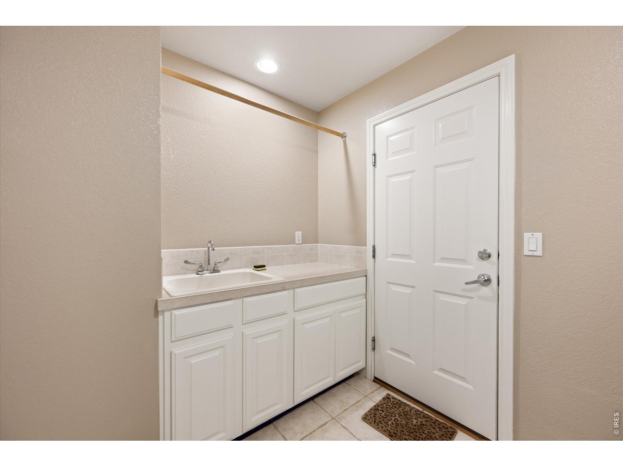Utility sink and extra cabinet storage in the laundry room for everyday functionality