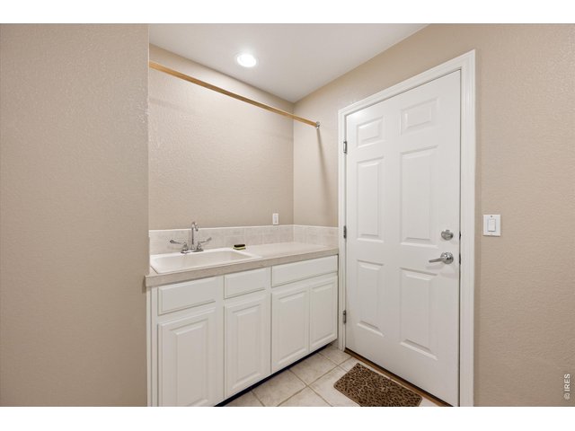 Property Photo 22 Utility sink and extra cabinet storage in the laundry room for everyday functionality