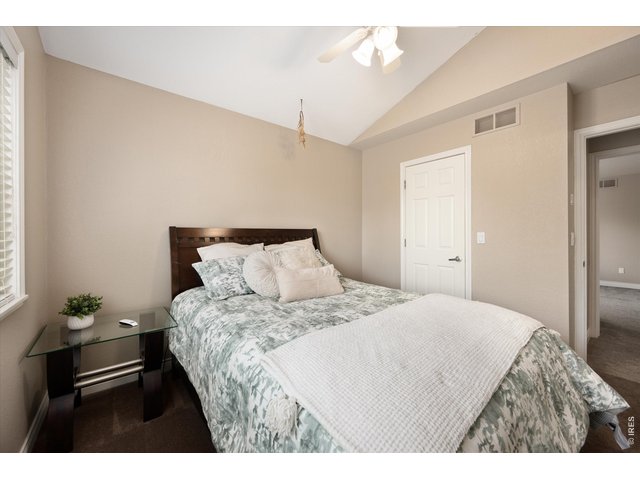 Property Photo 36 Spacious light-filled third bedroom with a comfortable layout and expansive closet space.