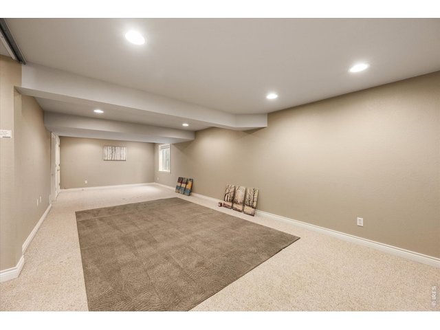 Property Photo 40 Expansive basement rec room with flexible living and entertaining space