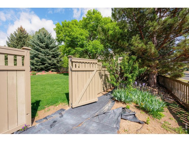 Property Photo 46 6ft privacy fence opening to a thoughtfully designed garden area