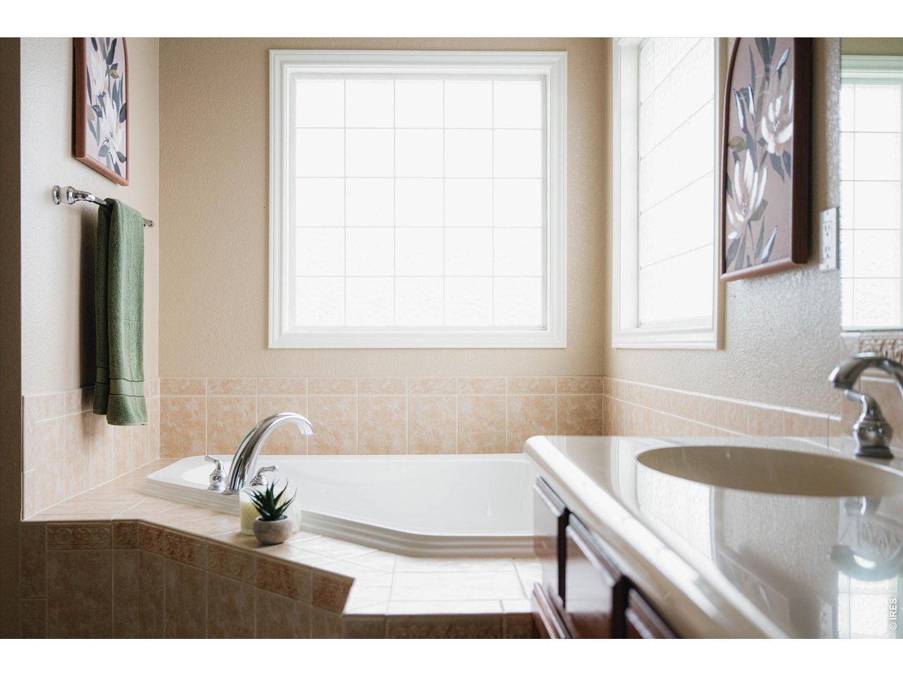 SPA-inspired primary bathroom with a jet tub and extended vanity counterspace