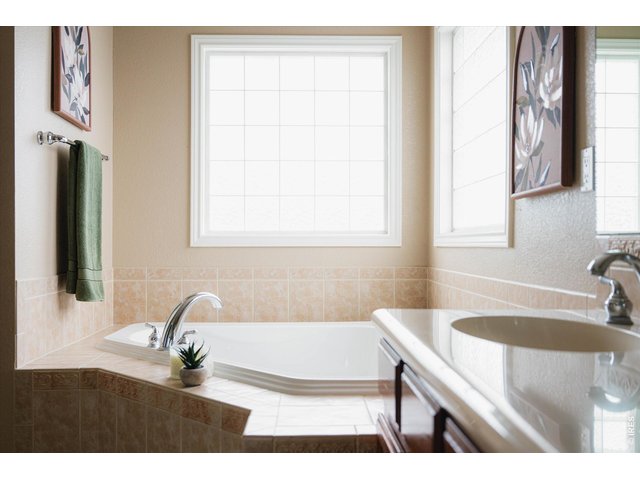 Property Photo 31 SPA-inspired primary bathroom with a jet tub and extended vanity counterspace