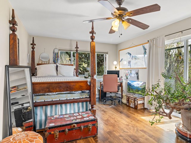 Property Photo 20 A second bedroom on the main level adds charm with custom built-ins, patio access, and a full bath conveniently located just across the hall