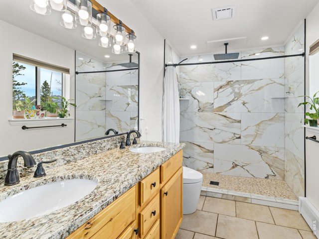 Property Photo 18 Beautifully remodeled 3/4 primary bathroom featuring a walk-in shower, granite, and tile finishes