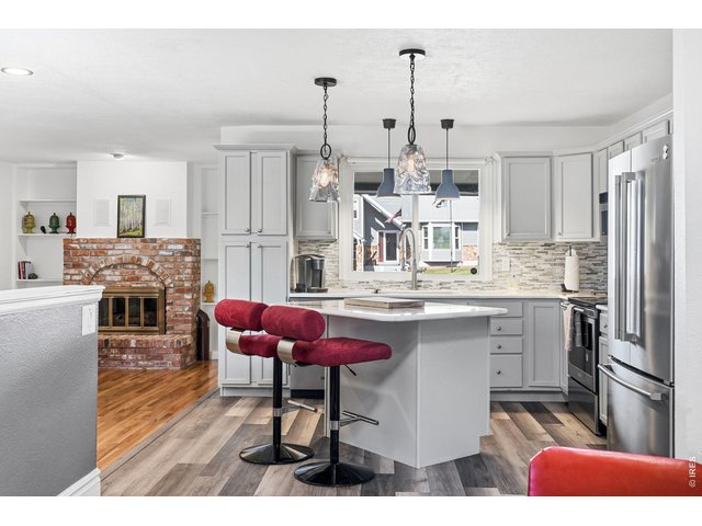 Property Photo 9 Updated kitchen with all appliances included, new countertops, backsplash, and a center island