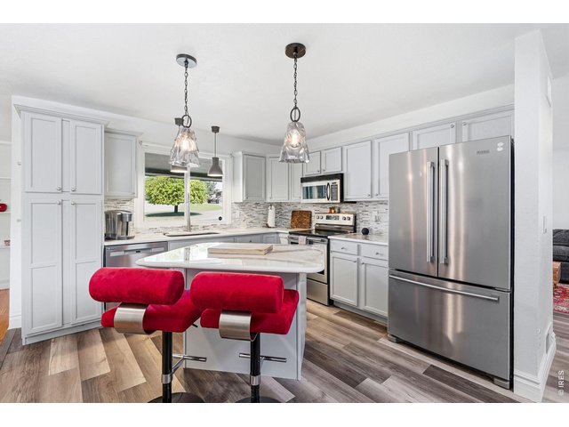 Property Photo 10 Updated kitchen with all appliances included, new countertops, backsplash, and a center island
