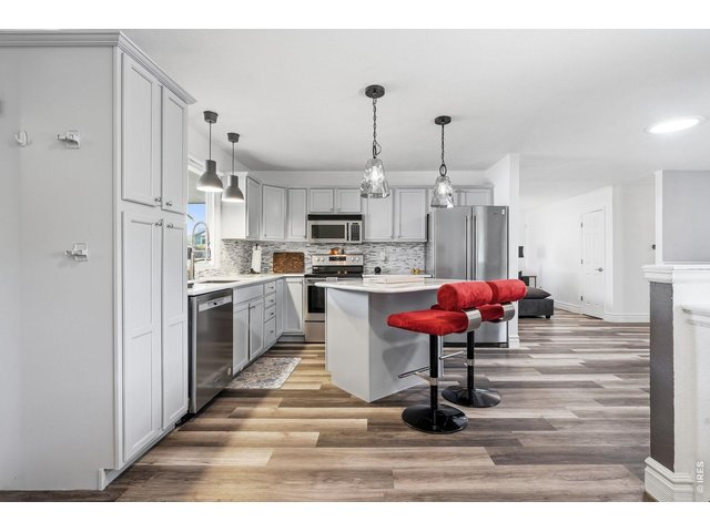 Property Photo 11 Updated kitchen with all appliances included, new countertops, backsplash, and a center island