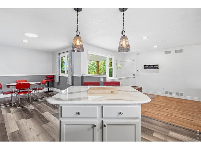 Property Photo 13 Updated kitchen with all appliances included, new countertops, backsplash, and a center island