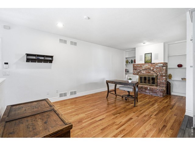 Property Photo 14 Just off the kitchen, the cozy family room offers a brick gas fireplace and built-in bookshelves