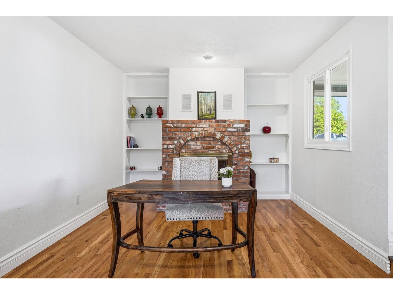 Just off the kitchen, the cozy family room offers a brick gas fireplace and built-in bookshelves
