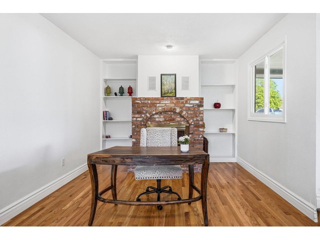 Property Photo 15 Just off the kitchen, the cozy family room offers a brick gas fireplace and built-in bookshelves