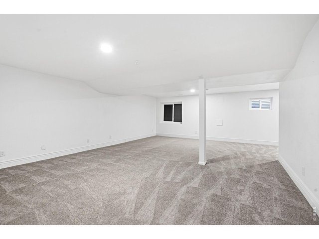 Property Photo 23 Expansive basement provides additional living space with new carpet, a large recreation room, laundry room (washer and dryer included), an additional bedroom, and two bathrooms 