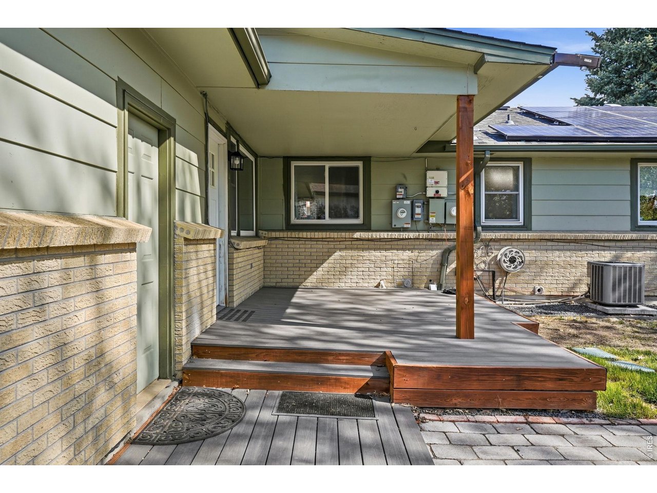 Private backyard oasis, complete with a Trex deck, pergola-covered patio, sprinkler system, and a concrete slab storage shed with electricity
