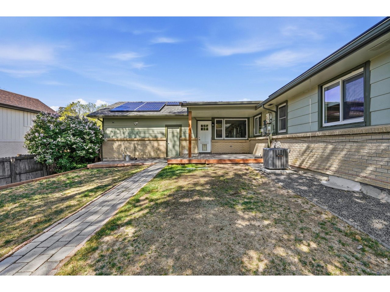 Private backyard oasis, complete with a Trex deck, pergola-covered patio, sprinkler system, and a concrete slab storage shed with electricity