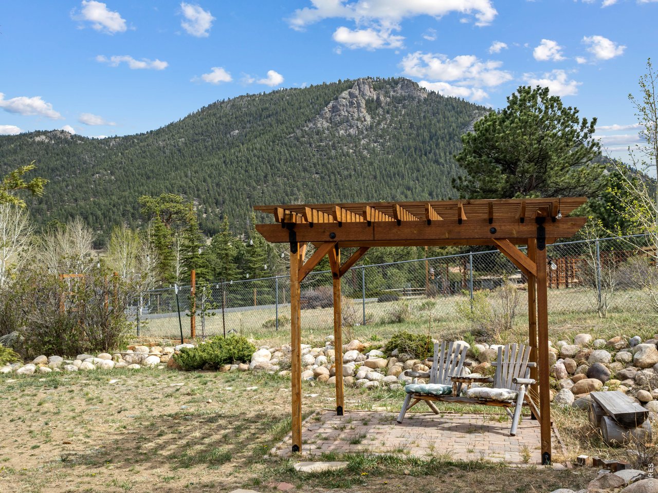 Large fenced in yard is nicely landscaped mountain style