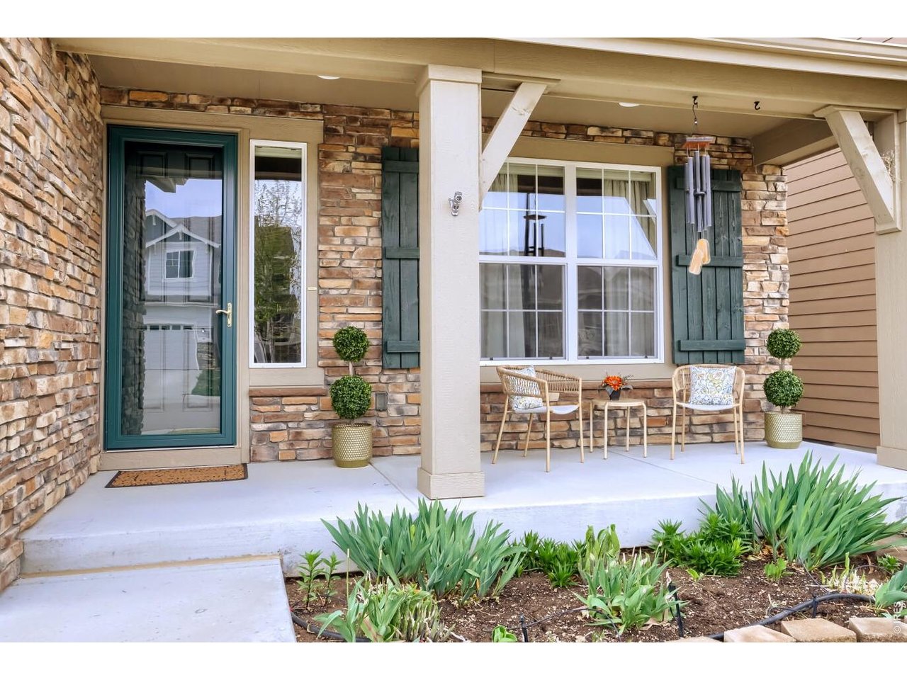 Covered front porch with beautiful landscaping