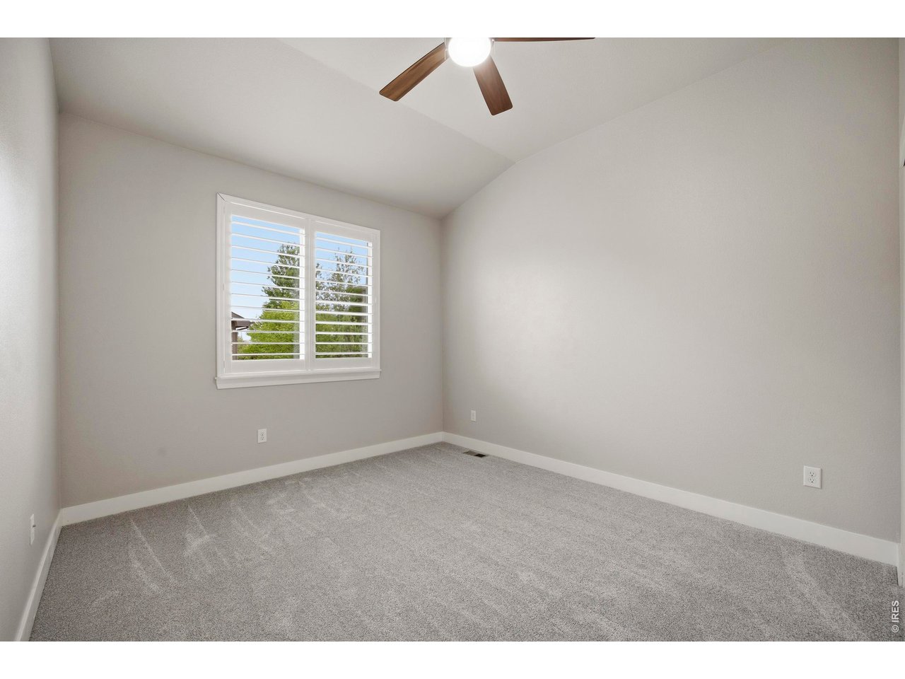Bedroom 3 on Main Level with Custom Shutters and Ceiling Fan