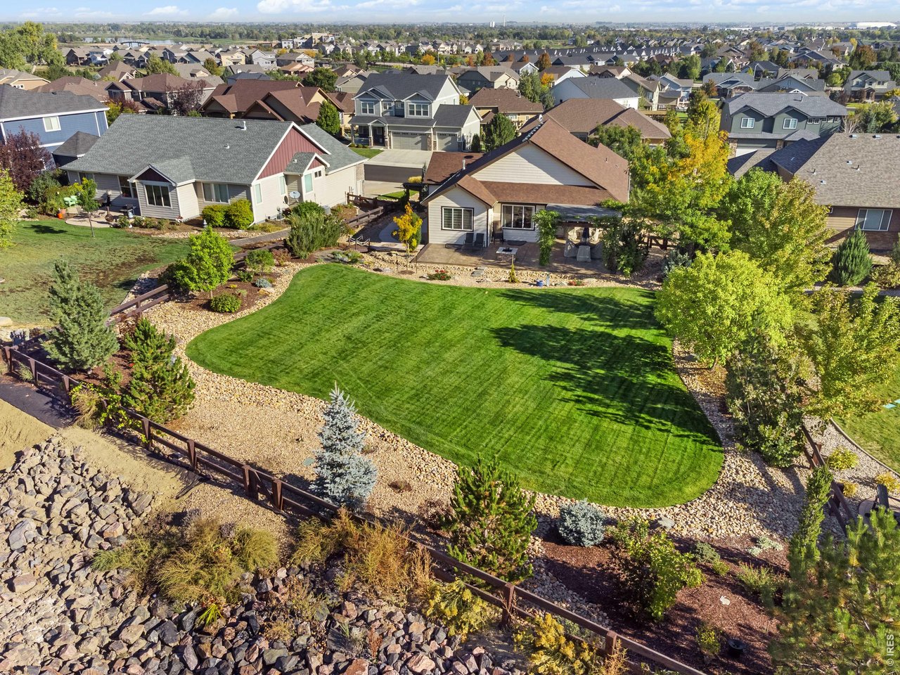 Beautifully landscaped yard and back gate to trails