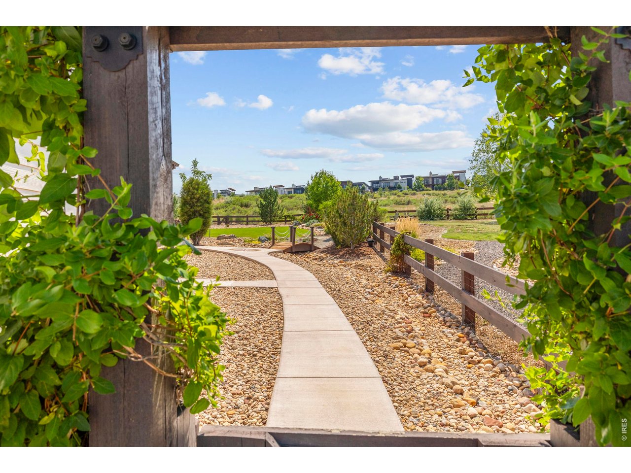 A peek view through the side of the house gate Pergola