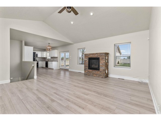 Property Photo 11 Inside, the ranch-style layout offers an open, vaulted living area with a gas fireplace, fully updated kitchen, and a main-level primary suite. 