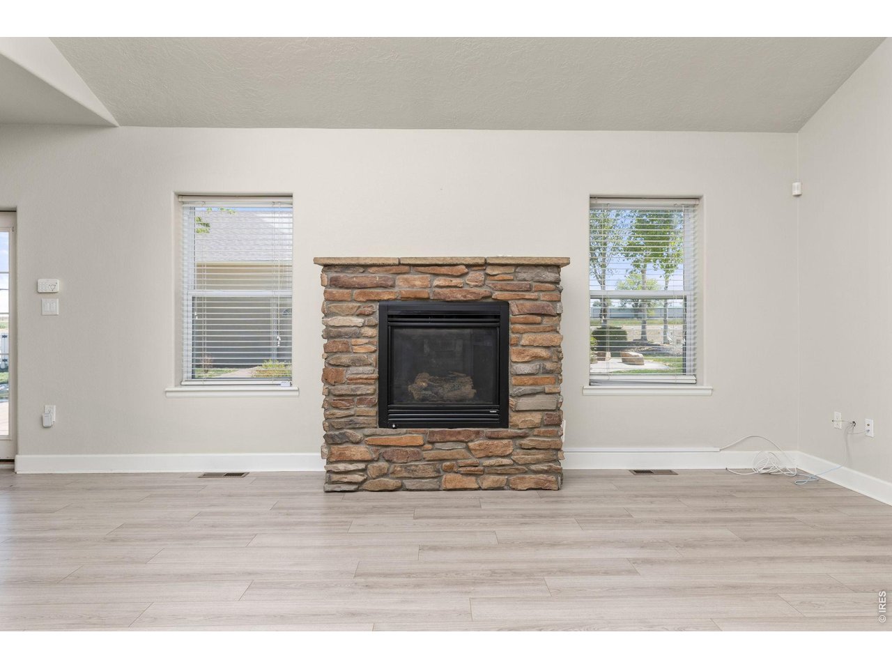 Inside, the ranch-style layout offers an open, vaulted living area with a gas fireplace, fully updated kitchen, and a main-level primary suite. 