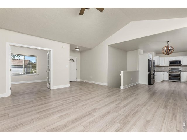 Property Photo 14 Inside, the ranch-style layout offers an open, vaulted living area with a gas fireplace, fully updated kitchen, and a main-level primary suite. 