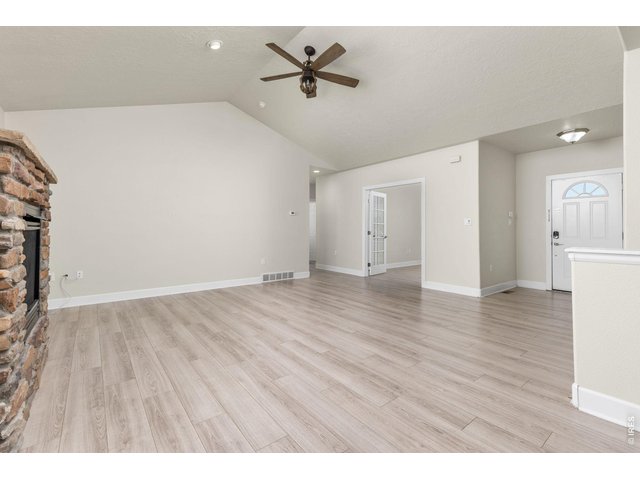 Property Photo 15 Inside, the ranch-style layout offers an open, vaulted living area with a gas fireplace, fully updated kitchen, and a main-level primary suite. 