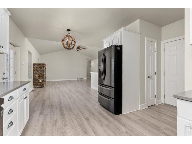 Property Photo 19 The kitchen has been updated with quartz countertops, subway tile backsplash, whitewash cabinetry, and newer appliances. 