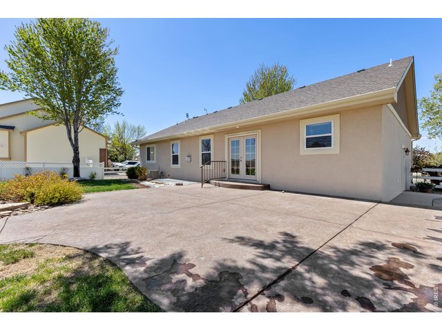 Property Photo 41 The backyard is built for enjoying Colorado living with mature trees, a spacious 550 sq ft stamped patio, and a dedicated firepit area perfect for entertaining on summer evenings. Mature landscaping & trees. Sprinkler system in place. 