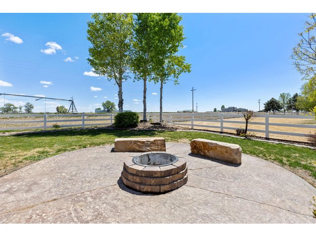 Property Photo 43 The backyard is built for enjoying Colorado living with mature trees, a spacious 550 sq ft stamped patio, and a dedicated firepit area perfect for entertaining on summer evenings. Mature landscaping & trees! Sprinkler system in place. 