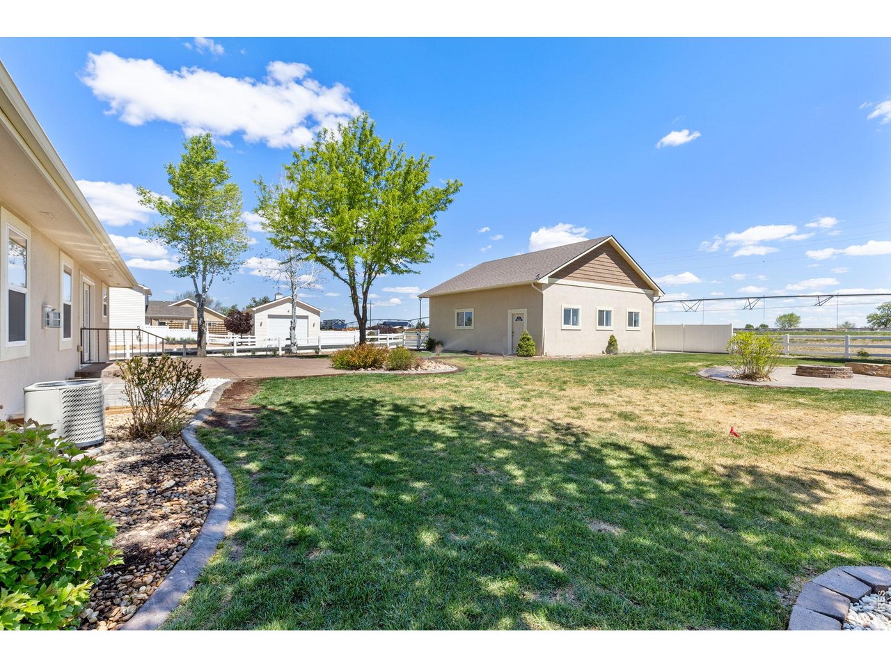 The backyard is built for enjoying Colorado living with mature trees, a spacious 550 sq ft stamped patio, and a dedicated firepit area perfect for entertaining on summer evenings. Mature landscaping & trees! Sprinkler system in place. 