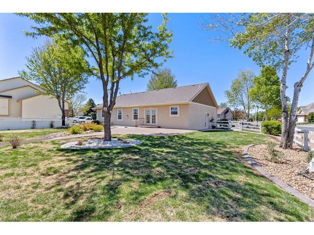 Property Photo 45 The backyard is built for enjoying Colorado living with mature trees, a spacious 550 sq ft stamped patio, and a dedicated firepit area perfect for entertaining on summer evenings. Mature landscaping & trees. Full sprinkler system. 