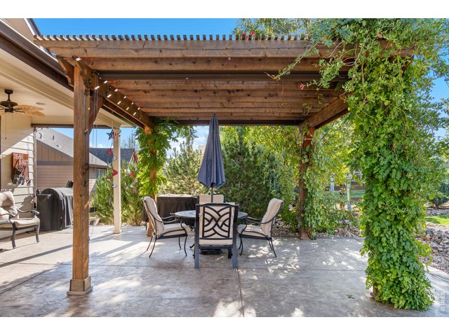 Property Photo 40 Pergola with 3 Roll Down Shades plus outdoor Ceiling Fan keeps you cool on hot summer days