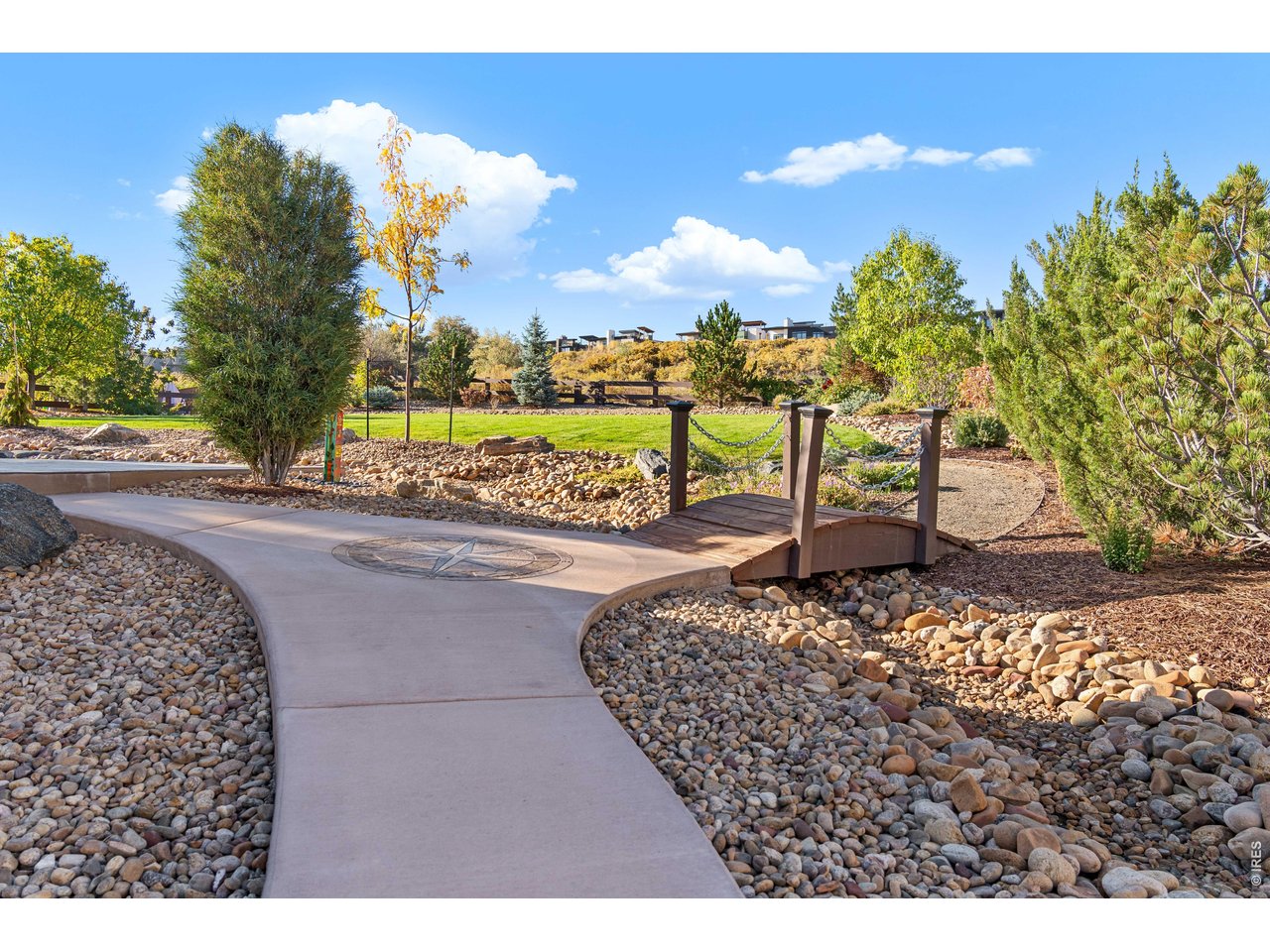 Fully Landscaped with walking bridge and mature trees. Rock River serves to direct flow of excess water for proper drainage