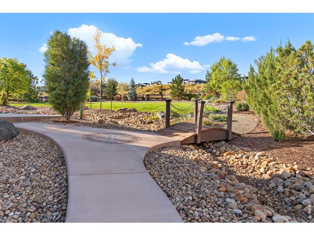 Property Photo 35 Fully Landscaped with walking bridge and mature trees. Rock River serves to direct flow of excess water for proper drainage