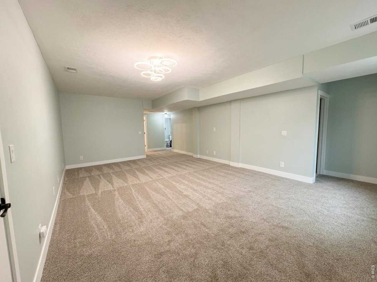 Property Photo 15 Great basement with new carpet, 4" trim and decorative doors and fixtures. In wall surround sound WIRED to add wall TV or projection TV