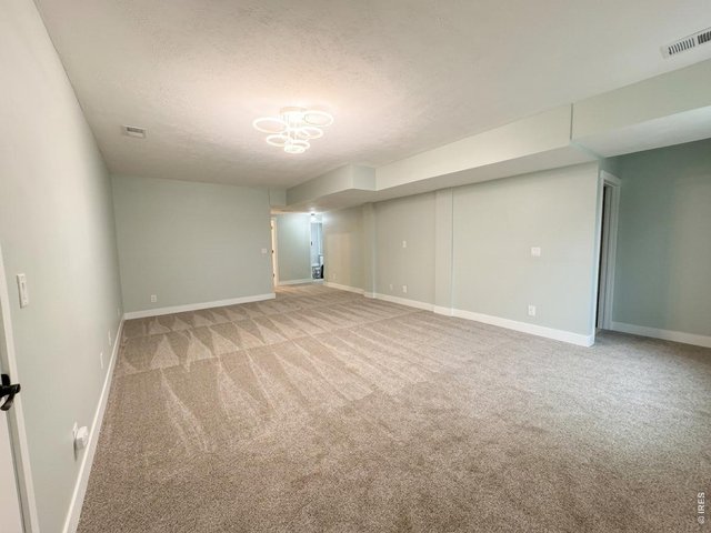 Property Photo 15 Great basement with new carpet, 4" trim and decorative doors and fixtures. In wall surround sound WIRED to add wall TV or projection TV