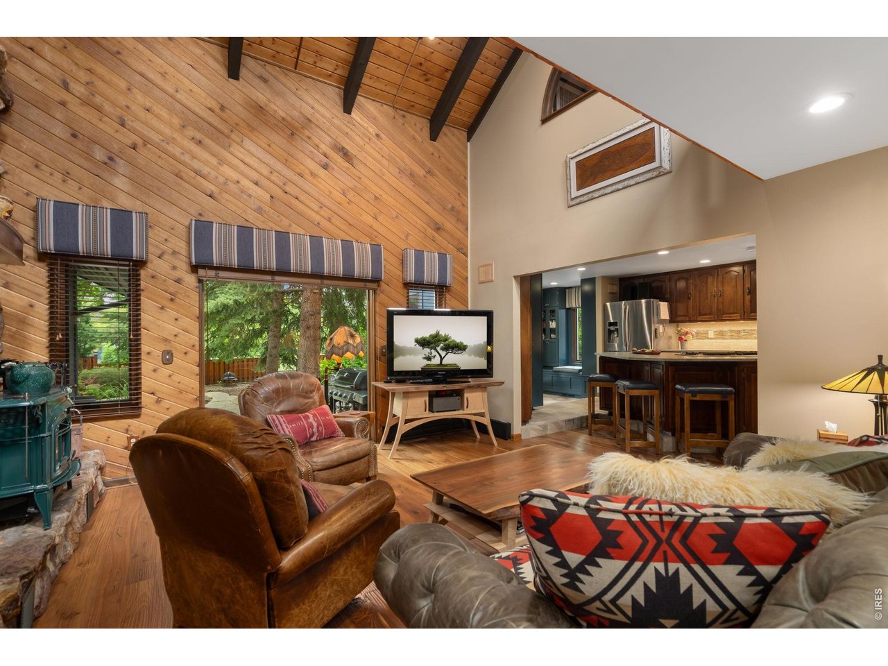 TV room/second living room area w/ T&G walls - vaulted with wood beams
