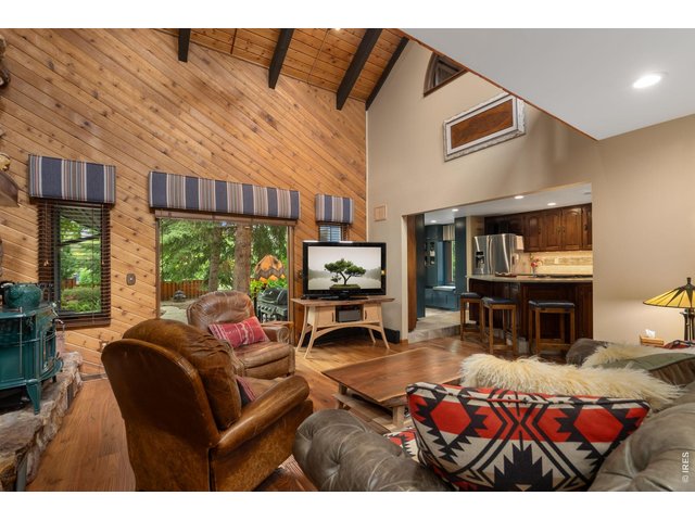 Property Photo 26 TV room/second living room area w/ T&G walls - vaulted with wood beams