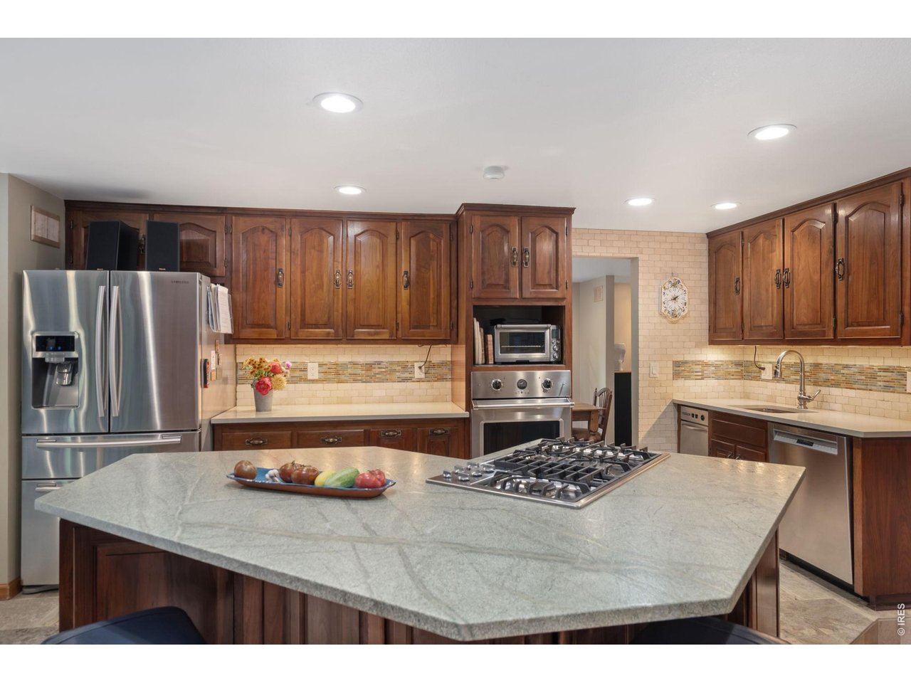 Kitchen remodeled in 2013 w/ quartz tops, leathered marble island, porcelain tile floors, wood cabinets