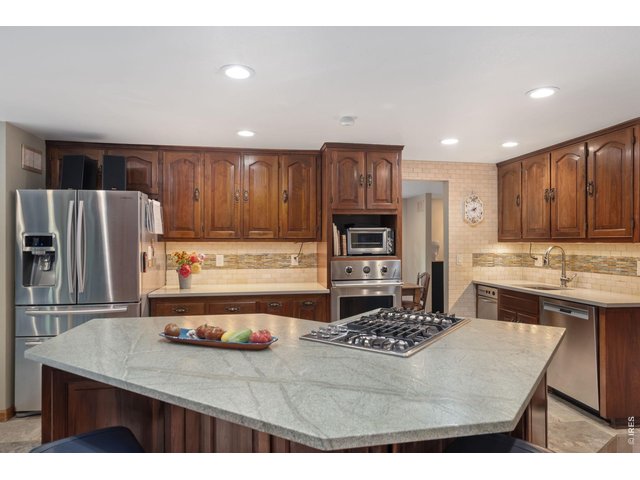 Property Photo 29 Kitchen remodeled in 2013 w/ quartz tops, leathered marble island, porcelain tile floors, wood cabinets